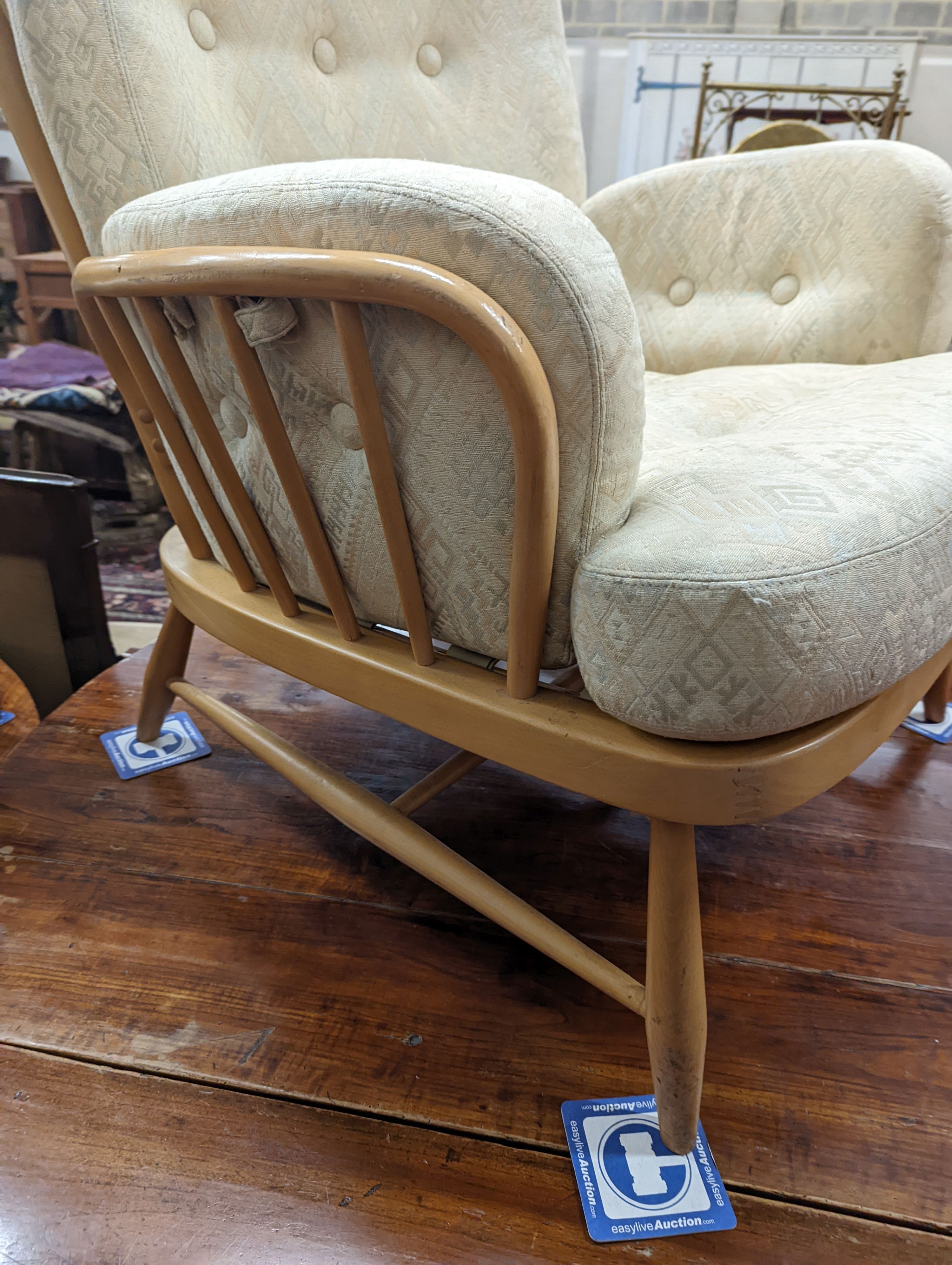 An Ercol Jubilee beech armchair with loose cushion upholstery, width 77cm, depth 80cm, height 86cm